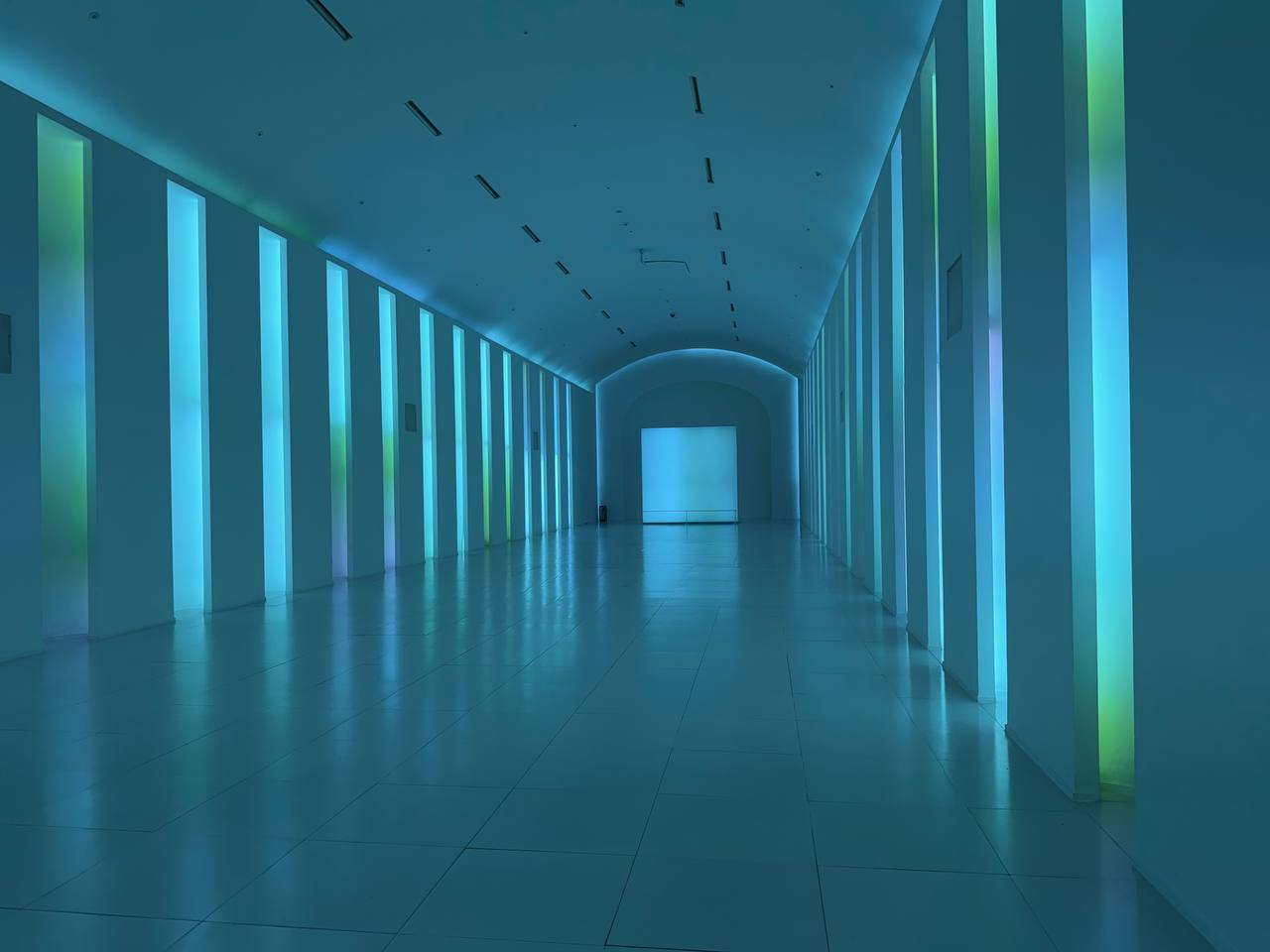 Illuminated teal tunnel corridor at Paradise City Incheon