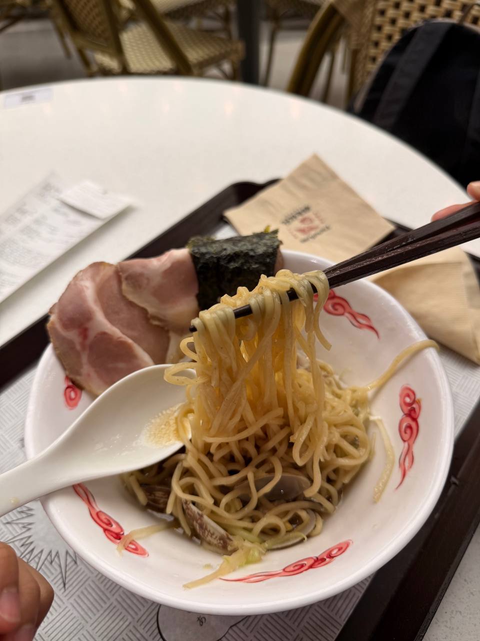 SARUKAME ramen noodles lifted chopsticks pork chashu nori Seoul