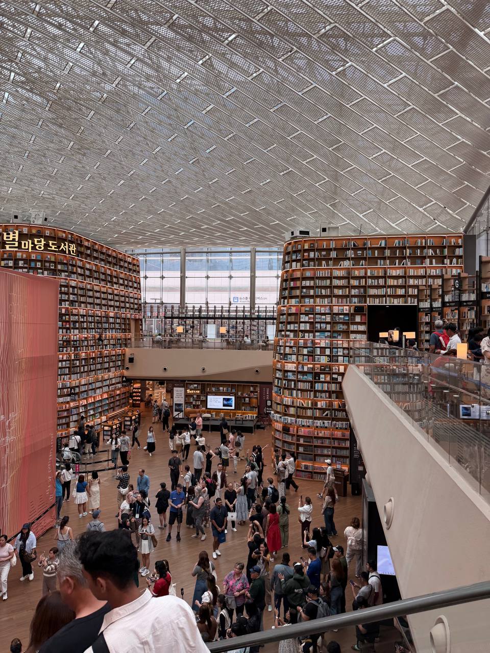 Starfield Library Seoul upper level view both book towers crowd