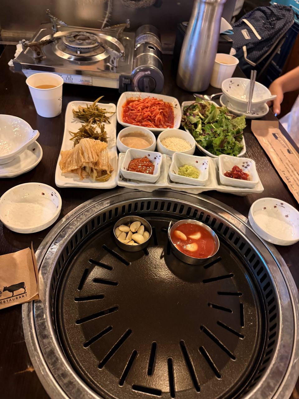 Hwapo Sikdang banchan side dishes and grill setup