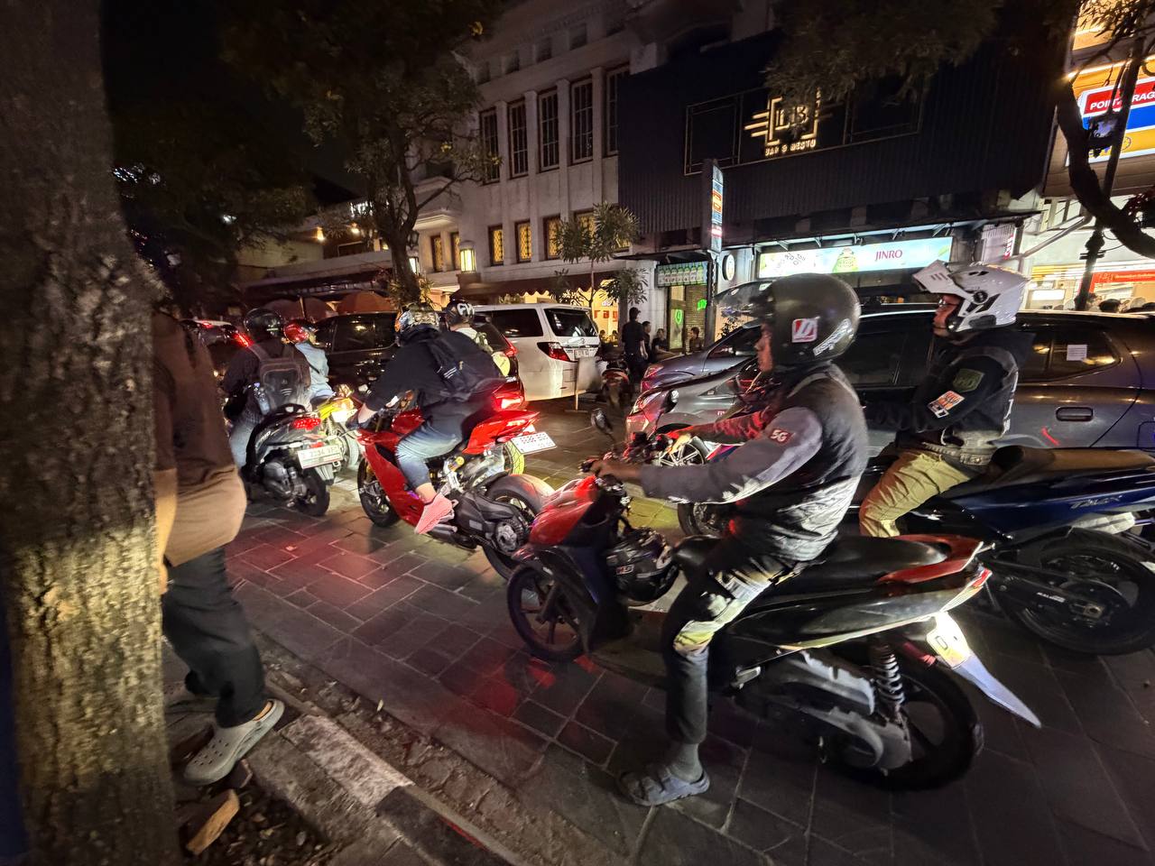 Motorbikes and crowds on Jalan Braga at night — LB Bar & Bistro and Point Braga signage, Bandung
