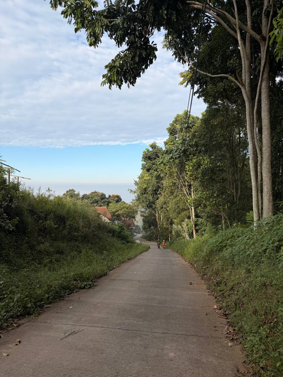 Panoramic sunrise view from Tebing Keraton — morning mist over the valley with Bandung mountain range silhouette