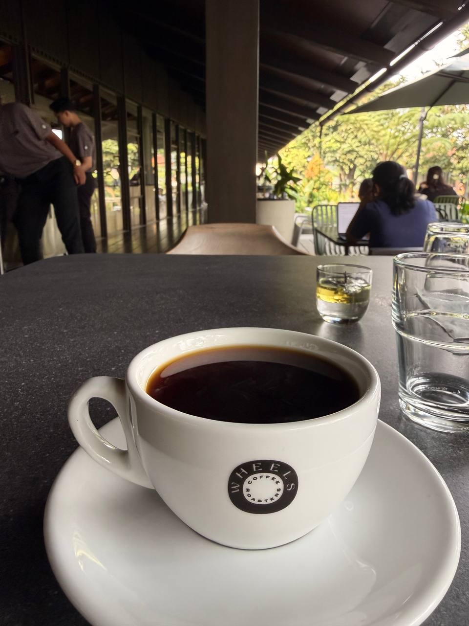 Black coffee in a Wheels Coffee Roasters cup — Dago, Bandung