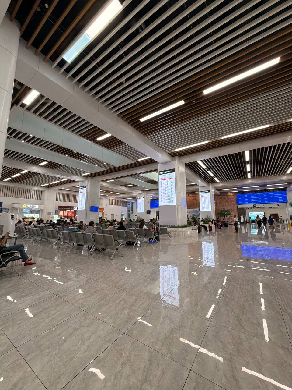 Main departure hall at Halim Station — schedule boards and waiting area for Whoosh train to Bandung