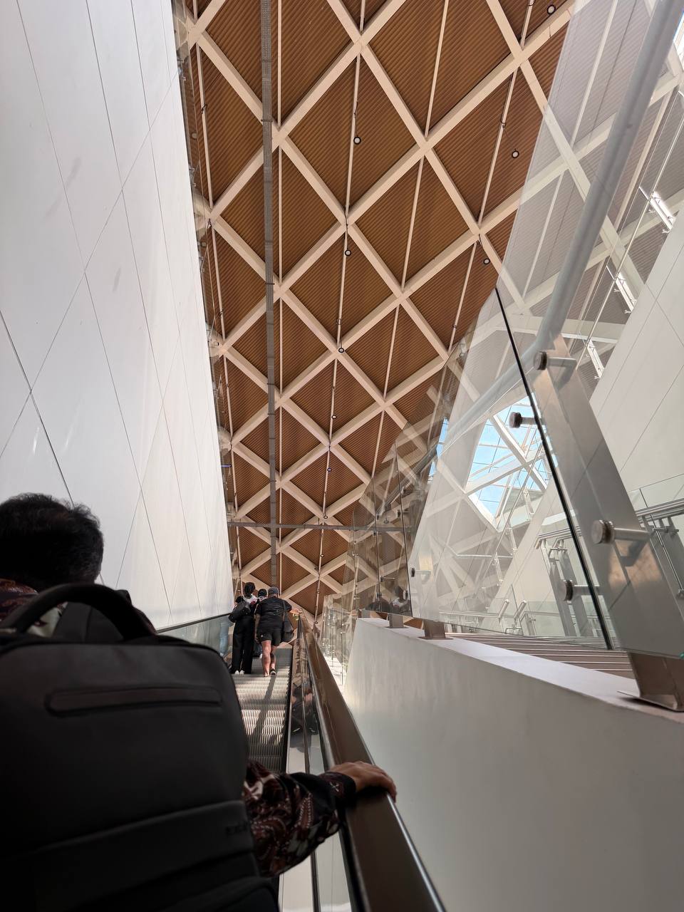 Inside Halim Station — dramatic coffered ceiling and escalators leading to the Whoosh departure level