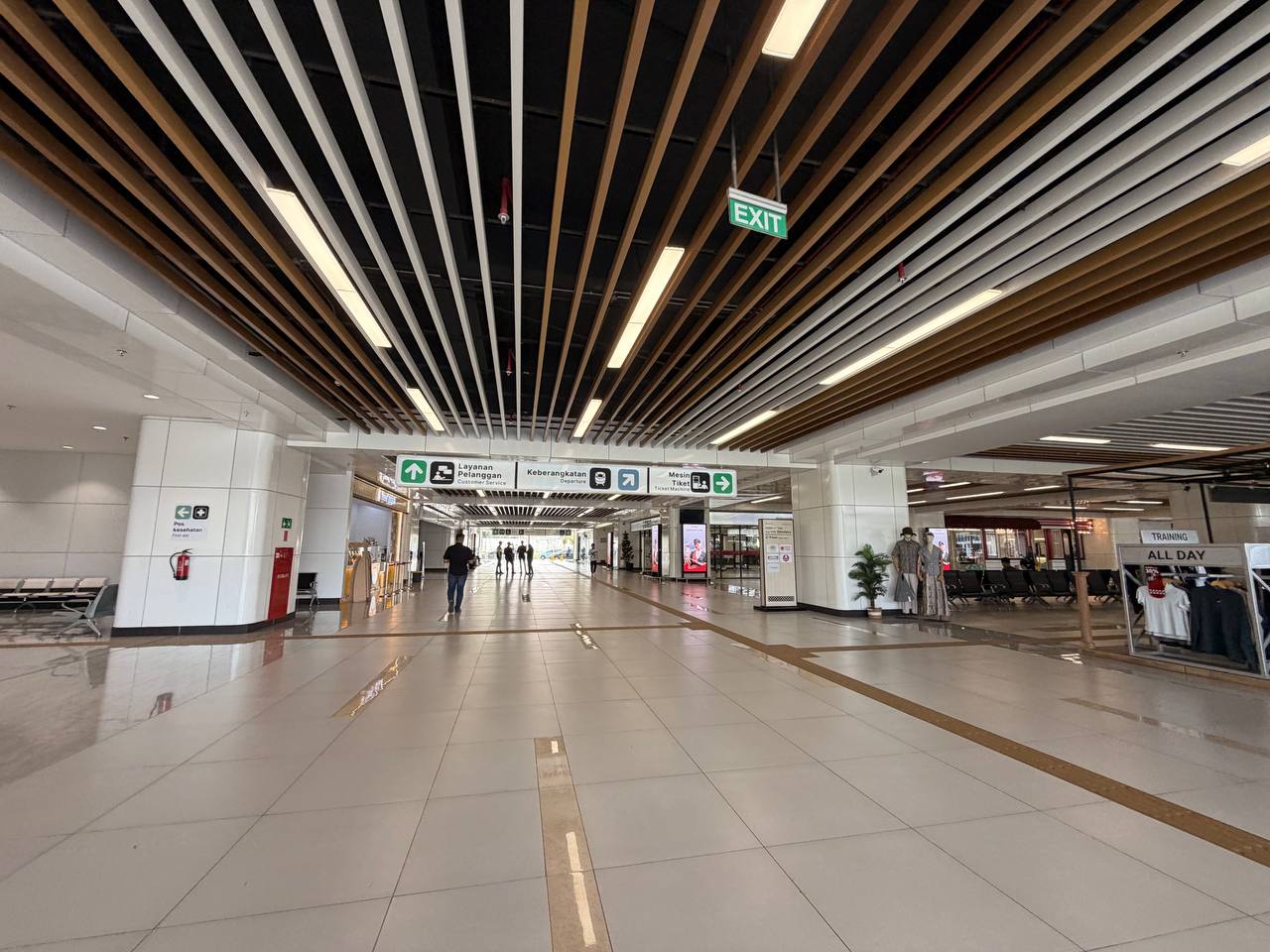 Bilingual wayfinding signs at Halim Station — Departure, Customer Service, Ticket Machine in Indonesian and English