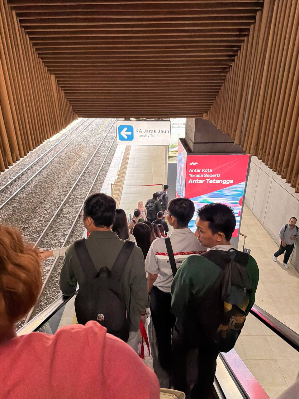 Padalarang station — KA Jarak Jauh intercity train signage and Whoosh advertisement at the transfer point