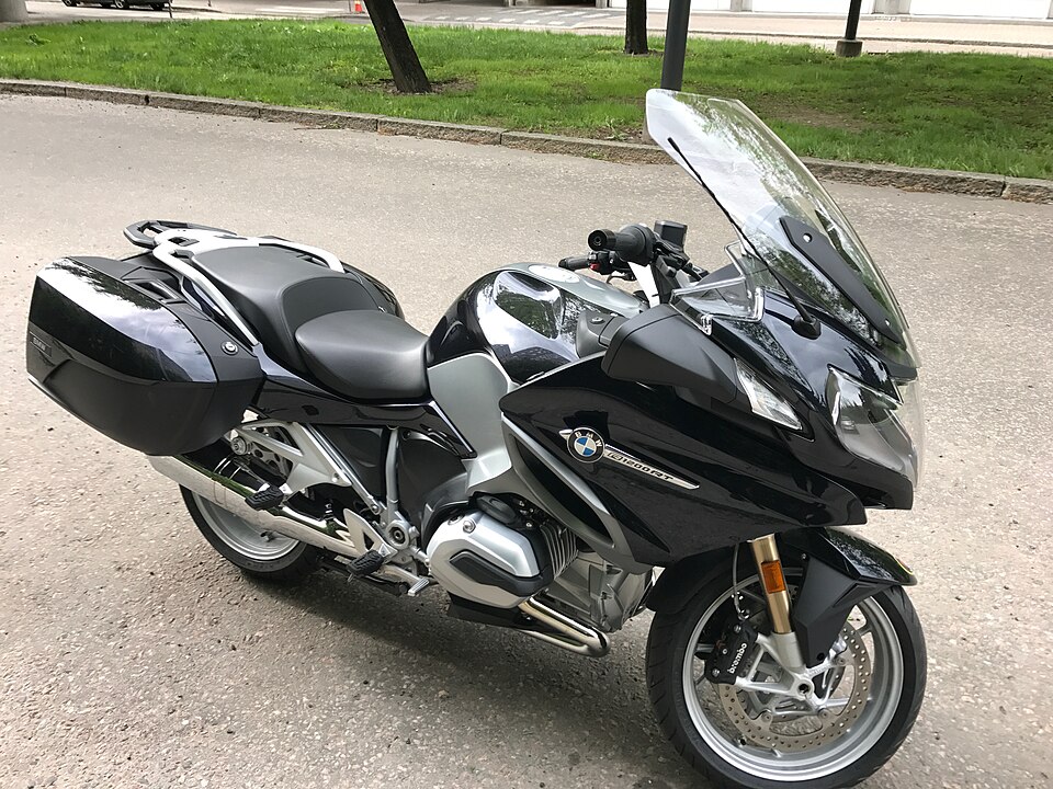 Black BMW R 1200 RT from 2017 with side cases, parked on pavement