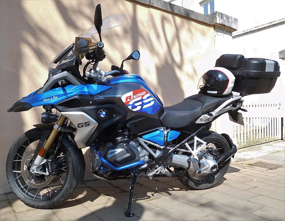 Blue BMW R 1250 GS adventure-touring motorcycle parked outdoors, viewed from the left side